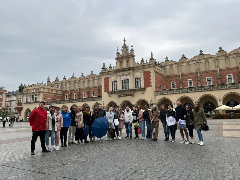 A tour group in front of the Cloth Hall on the Main Square