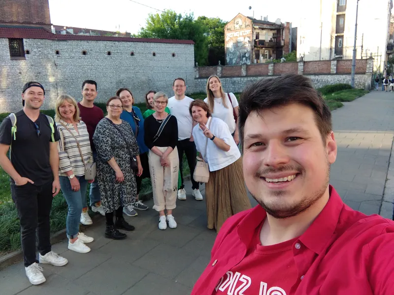 Konrad and a tour group by the old stone wall of the Jewish quarter