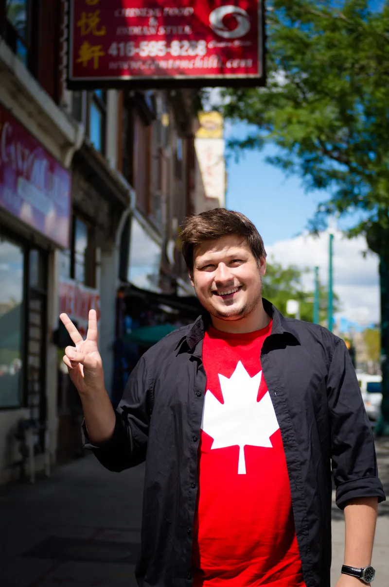 Konrad in a red Canada t-shirt on a street in Taiwan